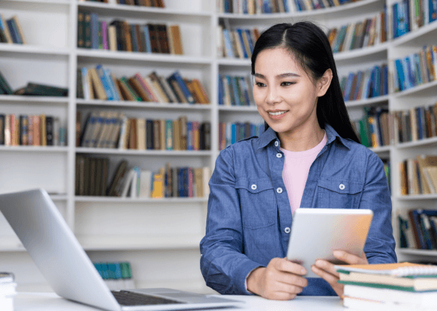Student checks thesis pages while ordering Translation Services in Malden for accurate academic translation and formatting.