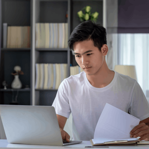 A student scans transcripts as Vietnamese Translation Services in Massachusetts prepares academic translations.
