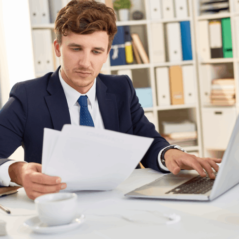A translator formats certified immigration paperwork using Portuguese Translation Services in Massachusetts on a laptop.