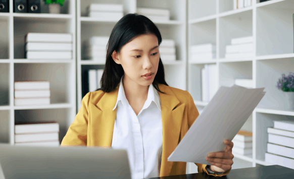 A translator checks USCIS-style paperwork as Chinese Translation Services in Massachusetts handles certified official docs.
