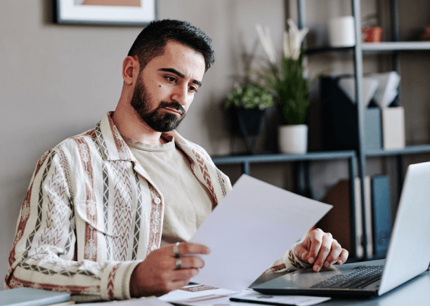 A client checks translated USCIS forms on a laptop, using Translation Services in Cambridge to avoid delays and errors.