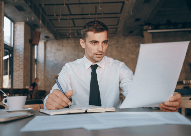 Compliance manager verifies translated business regulations using Translation Services in Boston to meet industry.