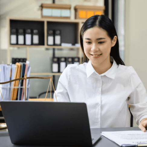 Lawyer checks a bilingual contract on a laptop, relying on Translation Services in Boston for legal translations.