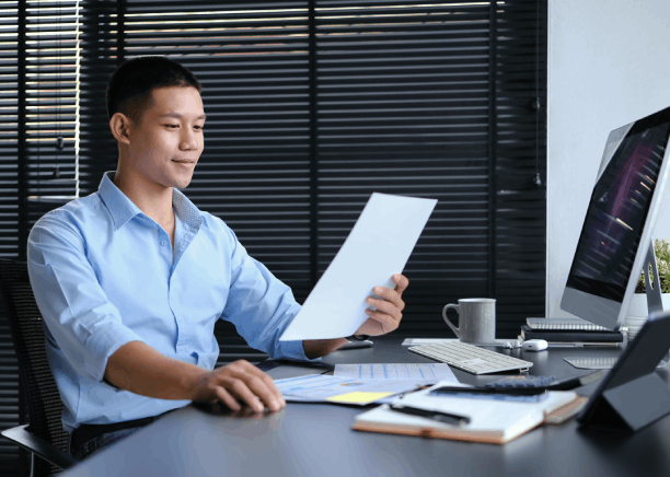 A translator checks engineering drawings with Chinese Translation Services in Massachusetts for technical documents.