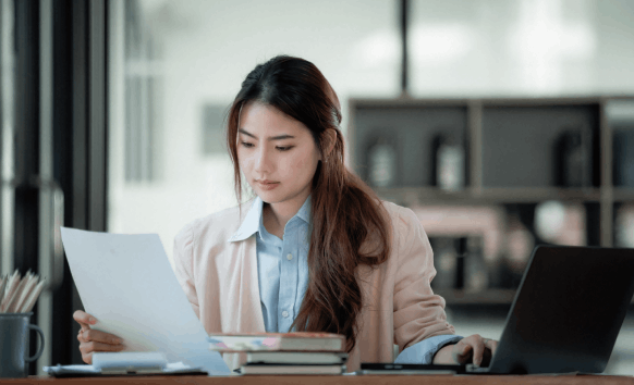 Professional translator reviews a document, showcasing Portuguese Translation Services in Massachusetts.