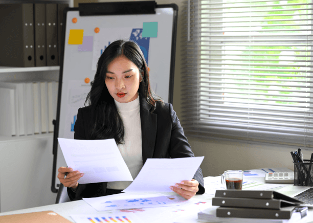 A translator checks USCIS forms and stamps a certified packet for Translation Services in Somerville compliance review.