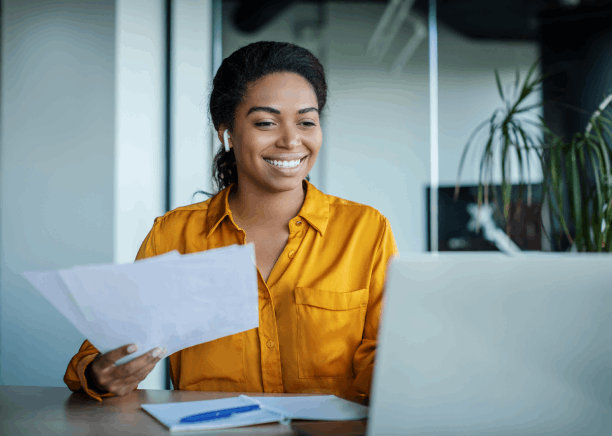 A bilingual reviewer checks names and dates on a personal form for Haitian Creole Translation Services in Massachusetts.