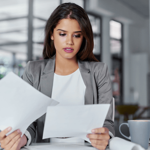 A manager checks a translated contract at a desk, relying on Translation Services in Somerville for business documents.