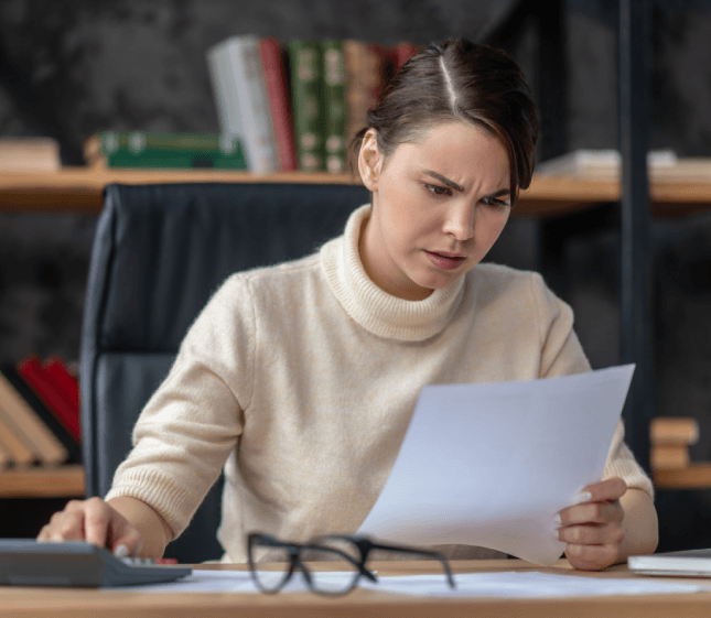 A linguist reviews a Spanish legal contract for Translation Services in Malden, checking clauses for accuracy and clarity.
