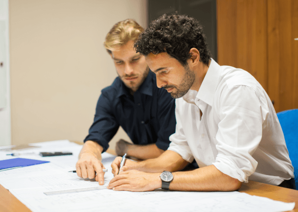 Engineer reviews a translated machine manual, showing technical Translation Services in Malden for manufacturing teams.