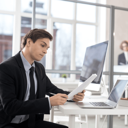 Translator checks USCIS requirements on a laptop while Translation Services in Medford formats USCIS documents for accuracy.