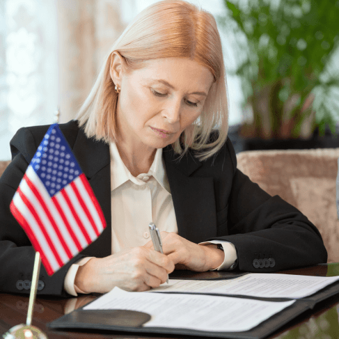 A translator checks USCIS-certified immigration forms at a desk, using Translation Services in Quincy for accuracy.