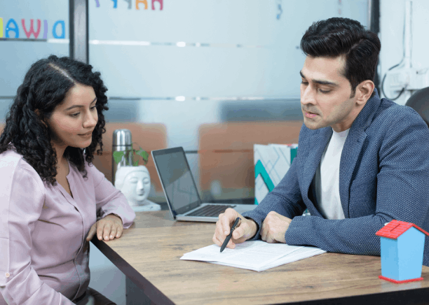 A translator consults a client about USCIS requirements using Portuguese Translation Services in Massachusetts in an office.
