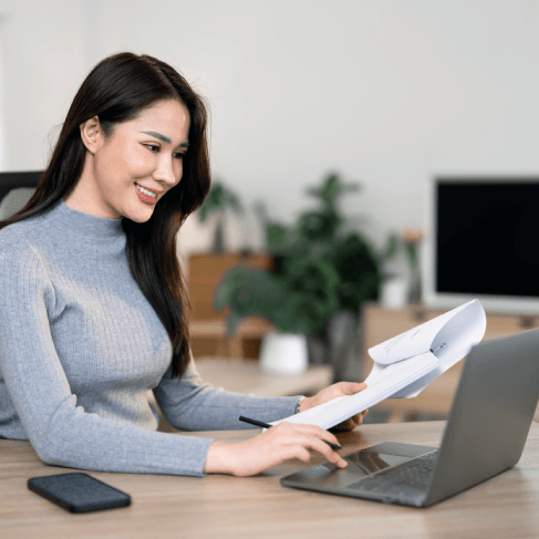Client receives a sealed USCIS immigration translation packet from Translation Services in Boston at a Boston office counter.